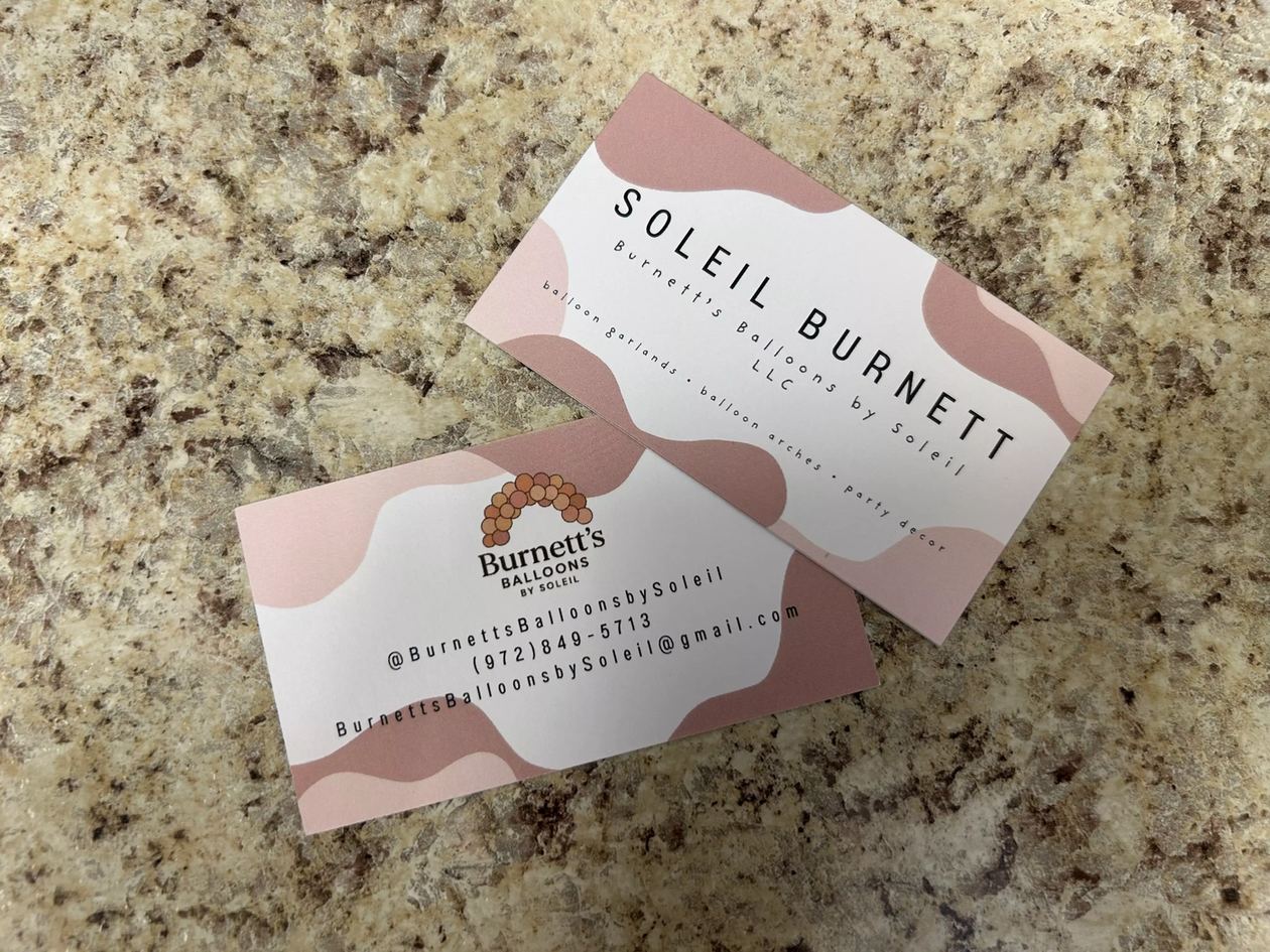 Burnett's Balloons by Soleil business cards showing the balloon arch logo, phone number and email address