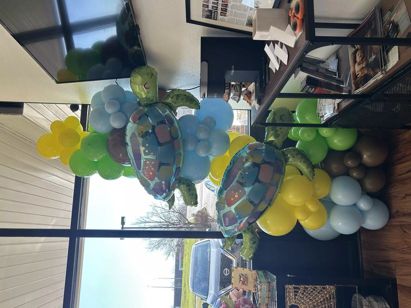 Sea turtle themed balloon garland in blue, green and yellow with two large turtle foil balloons